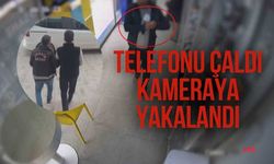 Camekandaki cep telefonunu kaşla göz arasında çalan hırsız kamerada